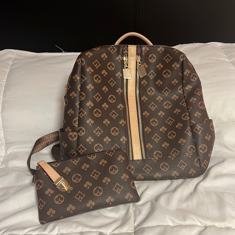 Unknown brand, it’s a gorgeous, roomy, purse backpack with wallet included!